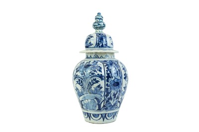 Lot 1133 - A Dutch Delft blue and white baluster vase and cover.