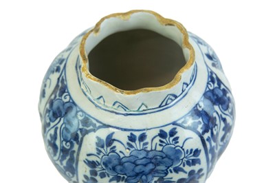 Lot 1133 - A Dutch Delft blue and white baluster vase and cover.