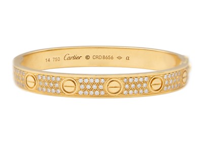 Lot 8 - CARTIER - An 18ct rose gold diamond set 'love' bangle.