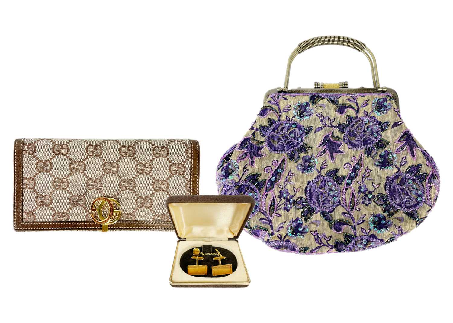 Lot 322 - GUCCI - A wallet in embroidered GG fabric and brown leather trim.