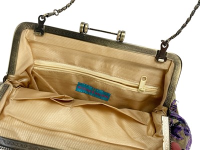 Lot 322 - GUCCI - A wallet in embroidered GG fabric and brown leather trim.