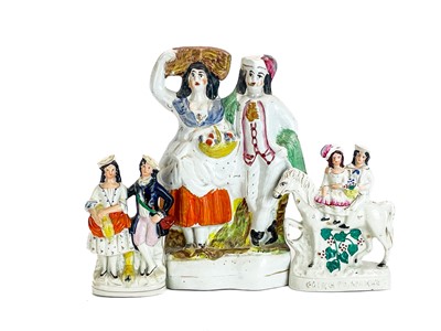Lot 486 - A Victorian Staffordshire pottery flat back figure group of a harvest couple.