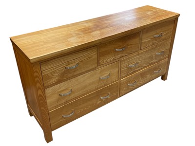 Lot 25 - A Blond Oak Chest of Drawers three over four....