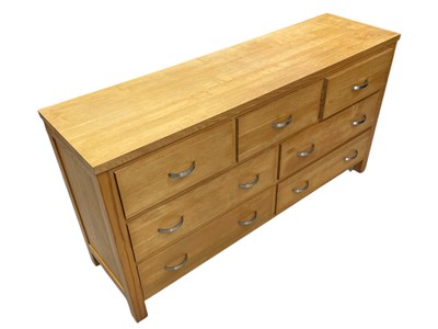 Lot 24 - A Blonde Oak Chest of Drawers three over four....