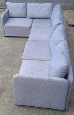 Lot 8 - A Corner Sofa. In a Grey Woven Material, the...