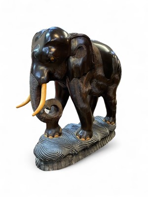 Lot 111 - An enormous carved ebonised wood figure of an elephant.