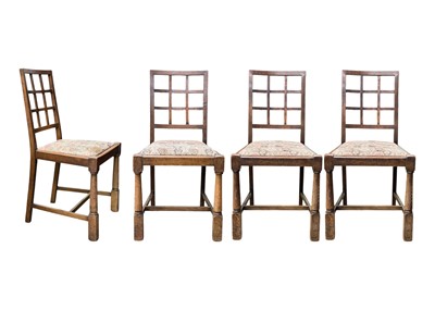 Lot 665 - A set of four Arts and Crafts oak dining chairs.