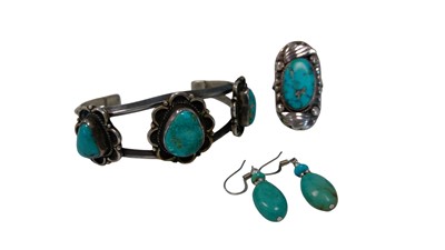 Lot 42 - A white metal bangle set with turquoise,...