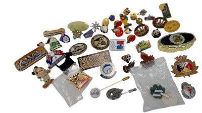 Lot 106 - A collection of mostly enamelled pin badges.