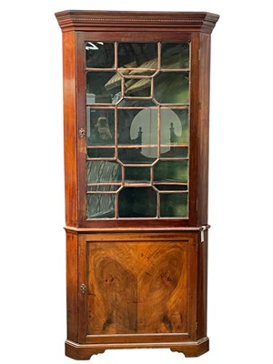 Lot 702 - A 19th century mahogany floor standing corner cupboard.