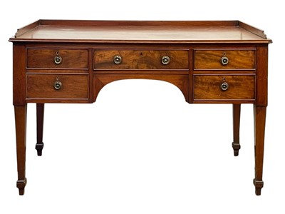 Lot 704 - A late George III mahogany galleried side table.