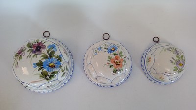 Lot 143 - Three ceramic handpainted nesting moulds,...