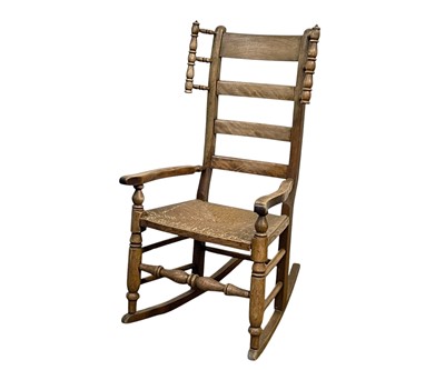 Lot 639 - An Arts and Crafts style beech and ash rocking chair.