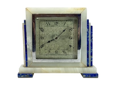 Lot 596 - An Art Deco English marble and lapis lazuli mounted timepiece.