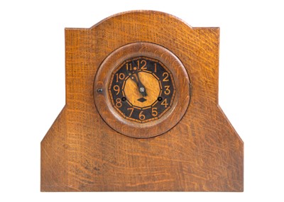 Lot 597 - An Arts and Crafts oak mantel clock.