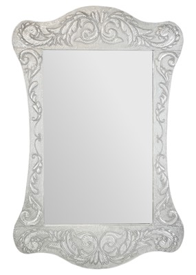 Lot 557 - An Arts and Crafts style pewter clad wall mirror.