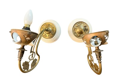 Lot 574 - A pair of Art Nouveau brass wall lights.