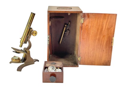 Lot 154 - A late Victorian brass and lacquered microscope.