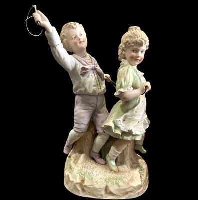 Lot 223 - A Heubach porcelain figure of a young boy and...