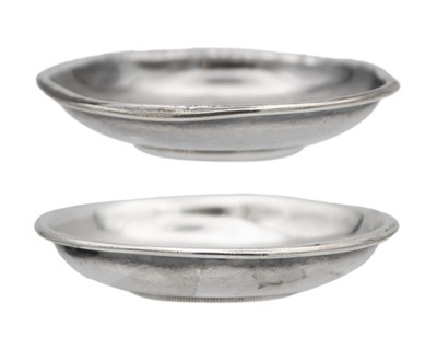 Lot 25 - A pair of Chinese silver Yuan empire inset one dollar coin pin dishes.