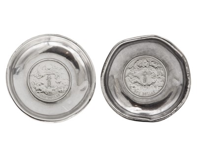 Lot 25 - A pair of Chinese silver Yuan empire inset one dollar coin pin dishes.