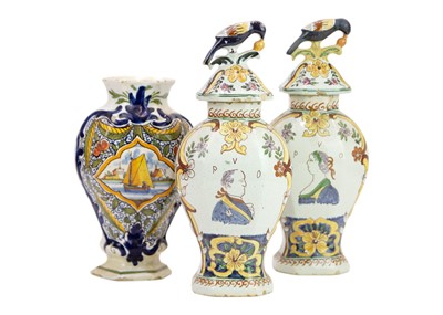 Lot 457 - A pair of Dutch Delft polychrome vases and covers.