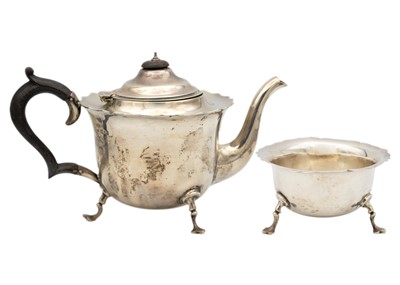 Lot 64 - An Edwardian silver two piece tea set by Robert Pringle & Sons.