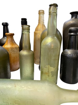 Lot 38 - 15 assorted glass bottles and two stoneware jars.