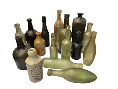 Lot 38 - 15 assorted glass bottles and two stoneware jars.