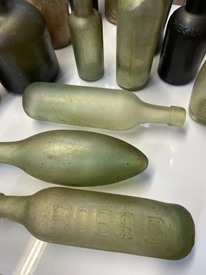 Lot 38 - 15 assorted glass bottles and two stoneware jars.