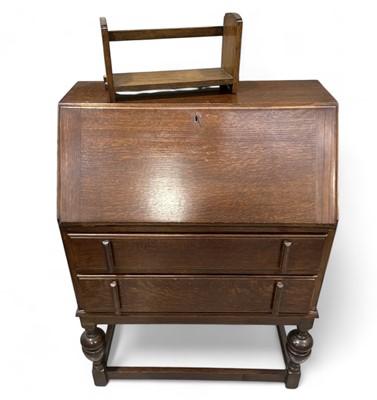 Lot 54 - An oak writing bureau and an oak book shelf.