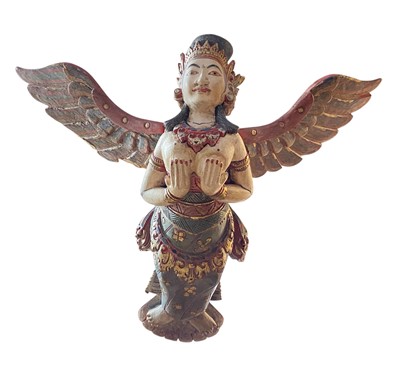 Lot 502 - A Balinese carved and painted wood winged goddess.