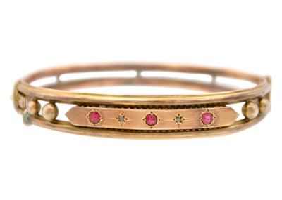 Lot 20 - A 9k rose gold hinged bangle.