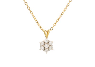 Lot 16 - An 18k gold diamond cluster pendant necklace.