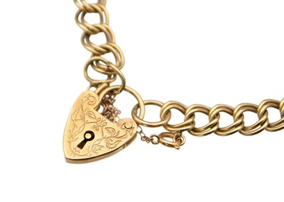 Lot 51 - A 9k double curb link bracelet, with a heart-shaped lock and a safety chain.