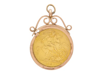 Lot 48 - A full sovereign coin encased in a 9k gold pendant.