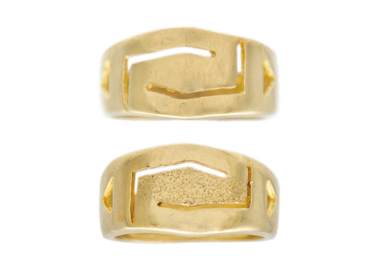 Lot 54 - A set of two 14k gold geometrical design band