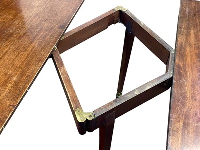 Lot 436 - A late George III mahogany concertina action dining table.