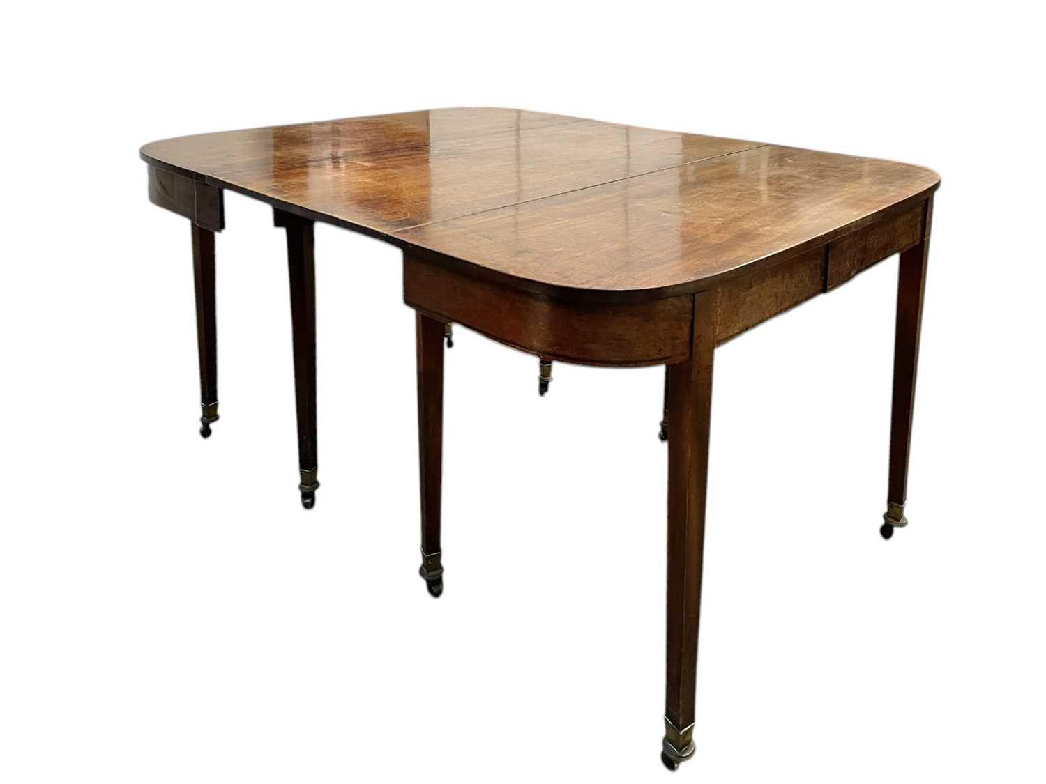 Lot 436 - A late George III mahogany concertina action dining table.