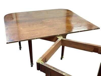 Lot 436 - A late George III mahogany concertina action dining table.