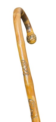 Lot 23 - A carved bamboo cane.