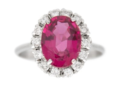 Lot 14 - A rubellite tourmaline and diamond halo white gold ring.