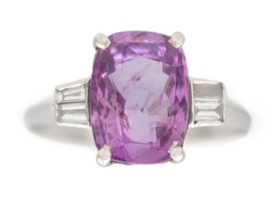 Lot 12 - A purplish pink sapphire and diamond set white gold ring.