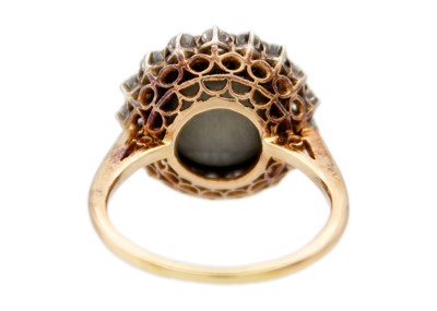 Lot 1 - A late Victorian cat's eye chrysoberyl and diamond halo yellow gold ring.