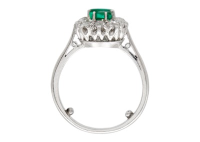 Lot 4 - An emerald and diamond white gold cluster ring.