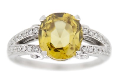 Lot 175 - A golden chrysoberyl and diamond platinum ring.