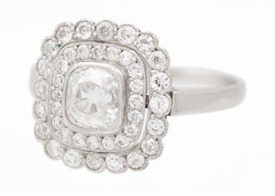 Lot 2 - An Art Deco old mine cut diamond cushion ring in platinum.