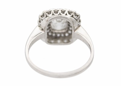 Lot 2 - An Art Deco old mine cut diamond cushion ring in platinum.