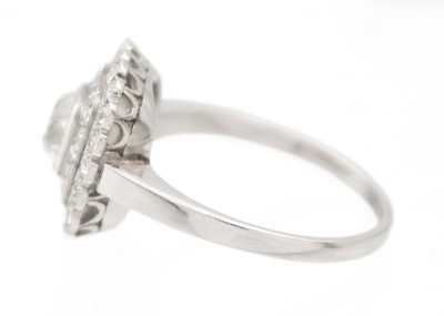 Lot 2 - An Art Deco old mine cut diamond cushion ring in platinum.