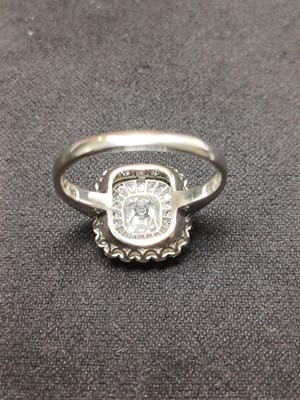 Lot 2 - An Art Deco old mine cut diamond cushion ring in platinum.